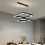 Ambiente comedor en plano abierto con luz neutra encendida.