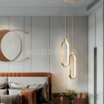 Lámpara Cameron Gold sobre pared de dormitorio moderno.