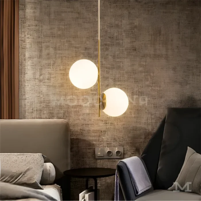 Luminaria Lucy Gold junto a cama en dormitorio decorado.