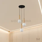 Luminaria Daysi Black and Gold en comedor con acabado dorado brillante. El diseño vertical realza la altura del ambiente y crea una atmósfera acogedora. Su luz LED cálida mejora la estética del mobiliario y da una sensación de amplitud.