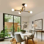 Luminaria negra con brazos dorados sobre comedor de estilo minimalista