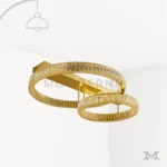 Luminaria Annelie Gold en fondo blanco con doble aro en acabado dorado brillante y luz LED integrada. Diseño moderno y elegante, ideal para iluminar salas y dormitorios con un estilo sofisticado.