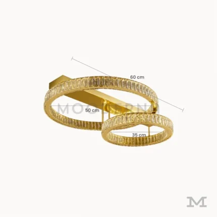 Luminaria Annelie Gold mostrando sus dimensiones reales de 50 cm y 35 cm en cada aro. Su estructura de aluminio y vidrio con LED integrado ofrece iluminación uniforme y estética sofisticada.