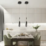 Amelux Black instalada sobre comedor, aportando iluminación focal y un acento moderno.