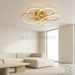 Lámpara LED dorada Lota Gold iluminada en sala moderna con decoración elegante