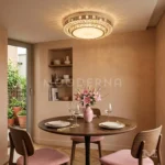 Luminaria LED Leandra de techo iluminando comedor moderno con mesa redonda de madera